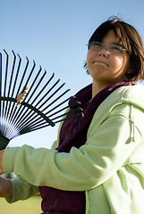 Image showing Girl Raking Leaves