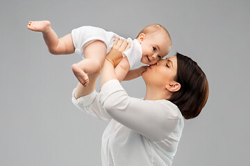 Image showing happy mother kissing little baby daughter