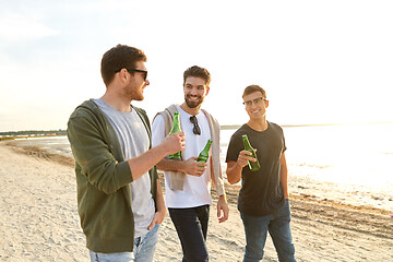 Image showing young men toasting non alcoholic beer on beach