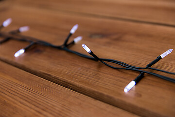 Image showing christmas garland lights on wooden background