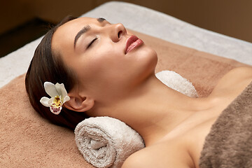 Image showing young woman lying at spa or massage parlor