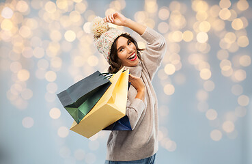 Image showing young woman in winter hat with shopping bags