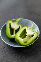 Image showing cut green pepper in bowl on slate stone background