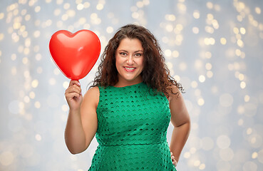 Image showing happy woman holding red heart shaped balloon