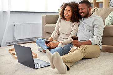 Image showing happy couple with laptop drinking red wine at home