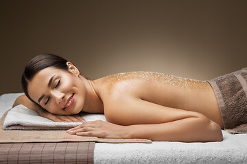 Image showing woman lying with sea salt on skin at spa