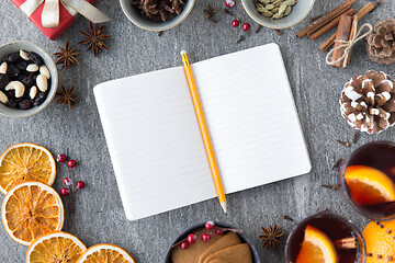 Image showing notebook, pencil and hot mulled wine on christmas