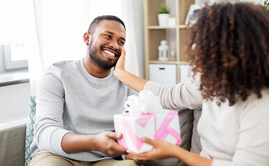 Image showing happy couple with gift at home