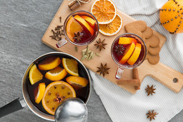 Image showing pot with hot mulled wine, orange slices and spices