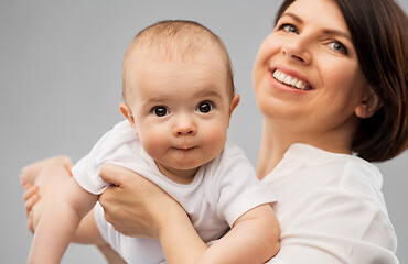 Image showing happy middle-aged mother with little baby daughter