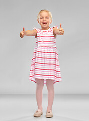 Image showing beautiful little smiling girl showing thumbs up