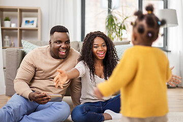 Image showing african family playing with baby daughter at home