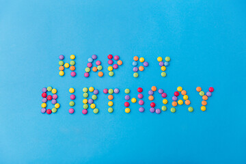 Image showing happy birthday of candy drops on blue background