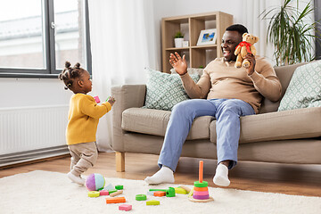 Image showing african american father playing with baby at home