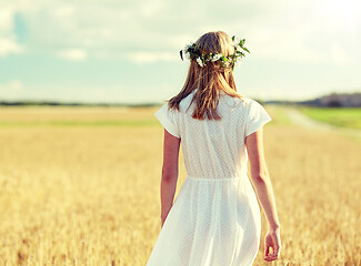 Image showing happy young woman in flower wreath on cereal field