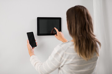 Image showing woman using tablet computer and smartphone