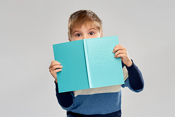 Image showing little boy hiding over book