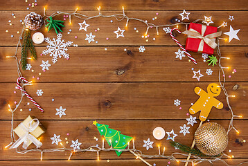 Image showing christmas gifts and decorations on wooden boards
