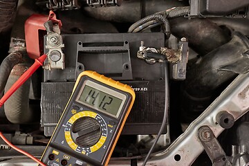 Image showing Checking car battery and alternator voltage with running engine