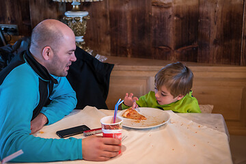 Image showing father his little son eating a pizza