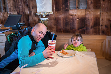 Image showing father his little son eating a pizza