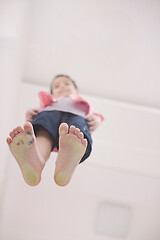 Image showing little boy standing on transparent glass floor