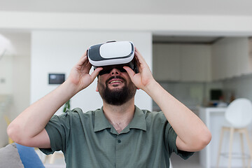 Image showing man with beard trying vr glasses