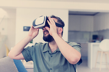 Image showing man with beard trying vr glasses