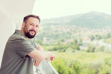 Image showing man standing on a modern balcony