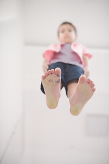 Image showing little boy standing on transparent glass floor