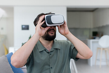 Image showing man with beard trying vr glasses