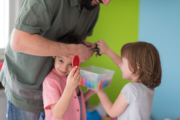 Image showing sister and brother havin fun and play hairstylist game at home