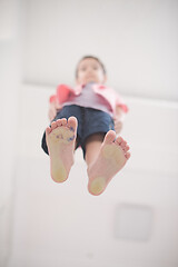 Image showing little boy standing on transparent glass floor