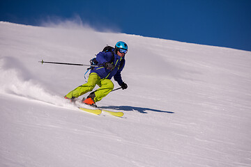 Image showing Skier having fun while running downhill