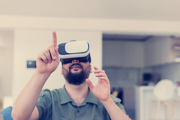 Image showing man with beard trying vr glasses