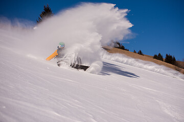 Image showing snowboarder crashes while carving down