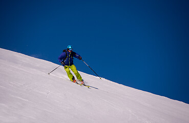 Image showing Skier having fun while running downhill