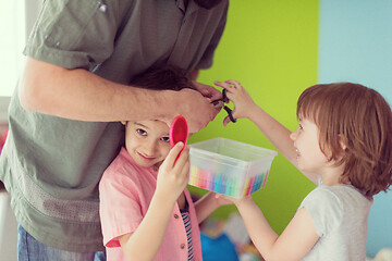 Image showing sister and brother havin fun and play hairstylist game at home