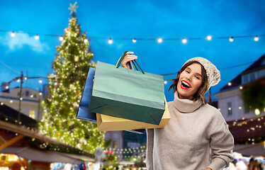 Image showing woman with shopping bags at christmas market