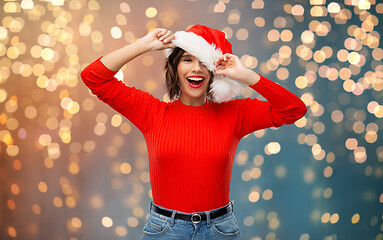 Image showing happy young woman in santa hat on christmas