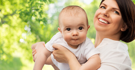 Image showing happy middle-aged mother with little baby daughter