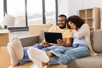 Image showing happy couple with tablet pc computer at new home