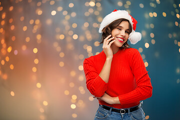 Image showing happy young woman in santa hat on christmas