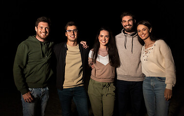 Image showing group of happy smiling friends outdoors at night