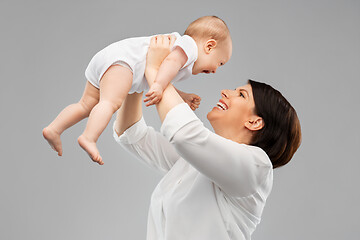 Image showing happy middle-aged mother with little baby daughter