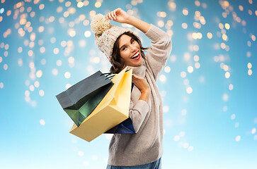 Image showing young woman in winter hat with shopping bags