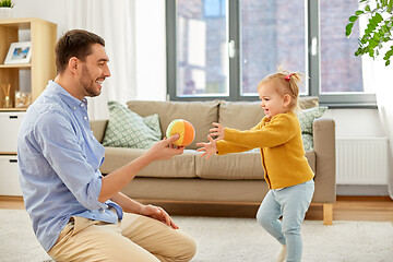 Image showing father and baby daughter playing with ball at home