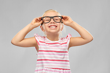 Image showing smiling cute little girl in black glasses