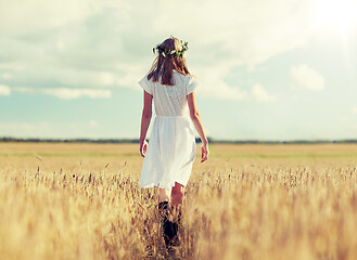 Image showing happy young woman in flower wreath on cereal field