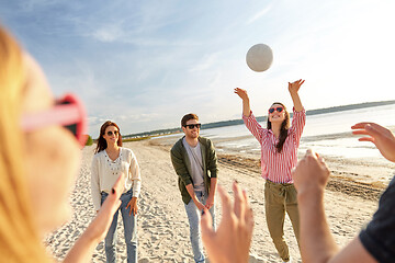 Image showing friends playing volleyball on beach in summer